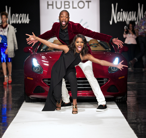 MIAMI, FL - NOVEMBER 18: Gabrielle Union and Dwyane Wade pose on the runway on the "A Night On The Runwade" fundrasing event  at Ice Palace Film Studios on November 18, 2014 in Miami, Florida. (Photo by Bobby Metelus/Getty Images)