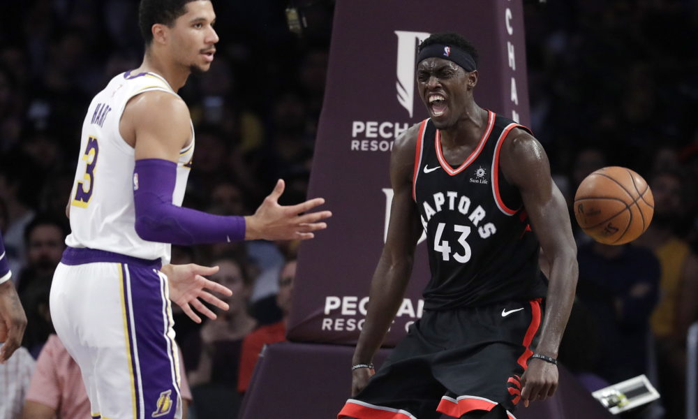 Toronto Raptors' Pascal Siakam, right, celebrates after dunking next to Los Angeles Lakers' Josh Hart (3) during the first half of an NBA basketball game Sunday, Nov. 4, 2018, in Los Angeles. (AP Photo/Marcio Jose Sanchez)