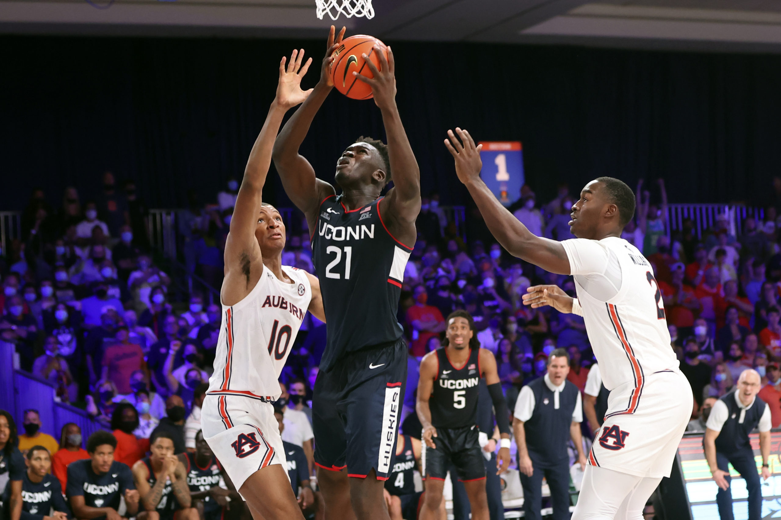 Nov 24, 2021; Nassau, BHS;  Connecticut Huskies forward Adama Sanogo (21) looks to score as Auburn Tigers forward Jabari Smith (10) defends during the game in the 2021 Battle 4 Atlantis at Imperial Arena. Mandatory Credit: Kevin Jairaj-USA TODAY Sports