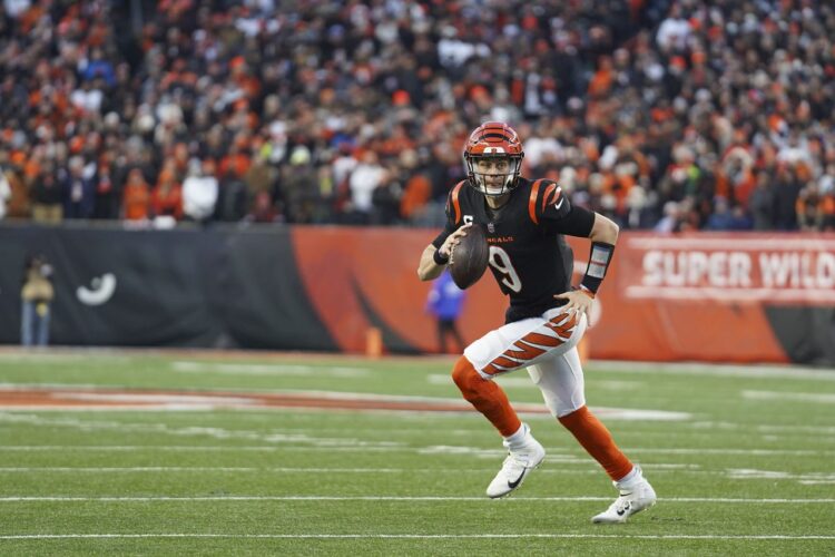 Cincinnati Bengals quarterback Joe Burrow (9) looks to throw during the first half of an NFL wild-card playoff football game against the Las Vegas Raiders, Saturday, Jan. 15, 2022, in Cincinnati. AP