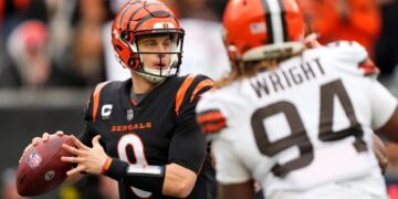 Cincinnati Bengals quarterback Joe Burrow (9) looks to throw under pressure in the second quarter during a Week 14 NFL game against the Cleveland Browns at Paycor Stadium.