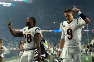 Cincinnati Bengals quarterback Joe Burrow (9) walks off the field with Cincinnati Bengals running back Joe Mixon (28) after winning the NFL game against the Los Angeles Rams at Paycor Stadium in Cincinnati on Monday, Sept. 25, 2023.