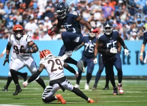 Oct 1, 2023; Nashville, Tennessee, USA; Tennessee Titans tight end Chigoziem Okonkwo (85) attempts to hurdle Cincinnati Bengals cornerback Cam Taylor-Britt (29) after a reception during the first half at Nissan Stadium. 