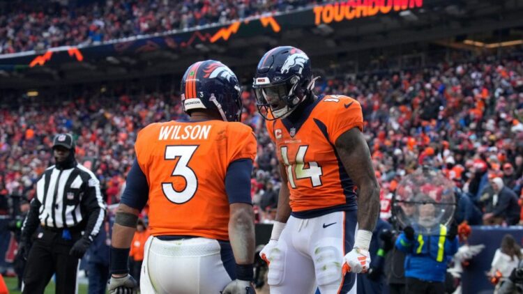 Denver Broncos wide receiver Courtland Sutton (14) is congratulated by quarterback Russell Wilson (3) after catching a touchdown pass during the second half of an NFL football game against the Kansas City Chiefs Sunday, Oct. 29, 2023, in Denver. (AP Photo/David Zalubowski)