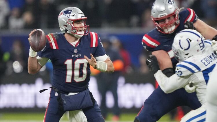 New England Patriots quarterback Mac Jones (10) drops back to pass under pressure from Indianapolis Colts defensive end Samson Ebukam (52) in the second half of an NFL football game in Frankfurt, Germany Sunday, Nov. 12, 2023. (AP Photo/Martin Meissner)