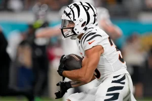 Cincinnati Bengals running back Chase Brown (30) takes a carry from Cincinnati Bengals quarterback Jake Browning (6) in the first half of a Week 13 NFL football game against the Jacksonville Jaguars, Monday, Dec. 4, 2023, at EverBank Stadium in Jacksonville, Fla. Cara Owsley/The Enquirer