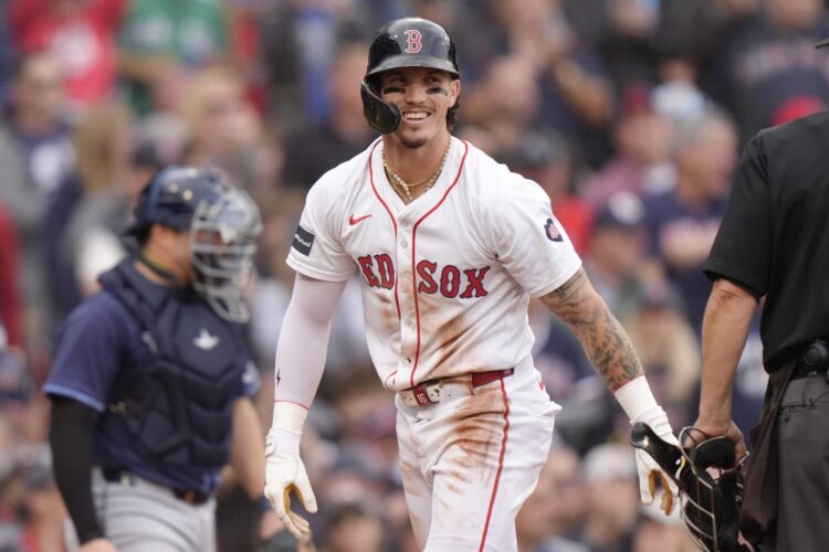 FILE - Boston Red Sox outfielder Jarren Duran, center, smiles after scoring on a Tampa Bay Rays error in the third inning of a baseball game Sunday, Sept. 29, 2024, in Boston. (AP Photo/Steven Senne, File)